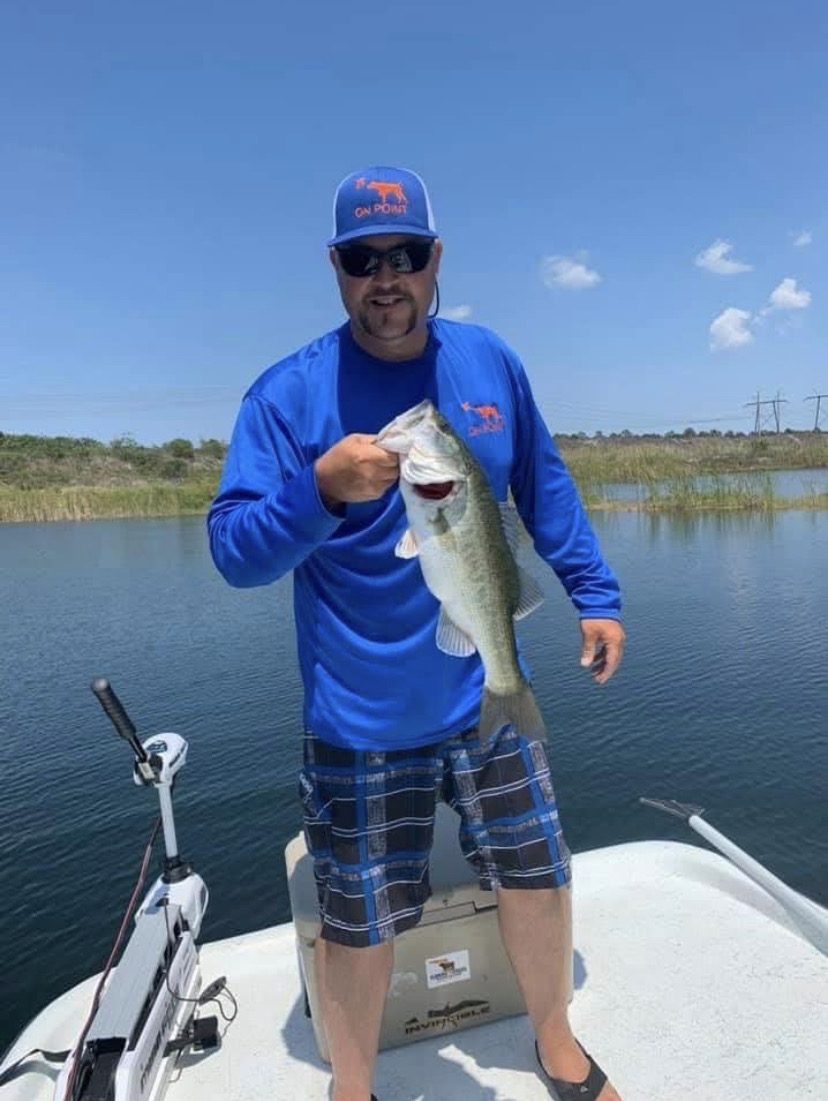 Todd Keller holding a bass caught on a Florida waterway